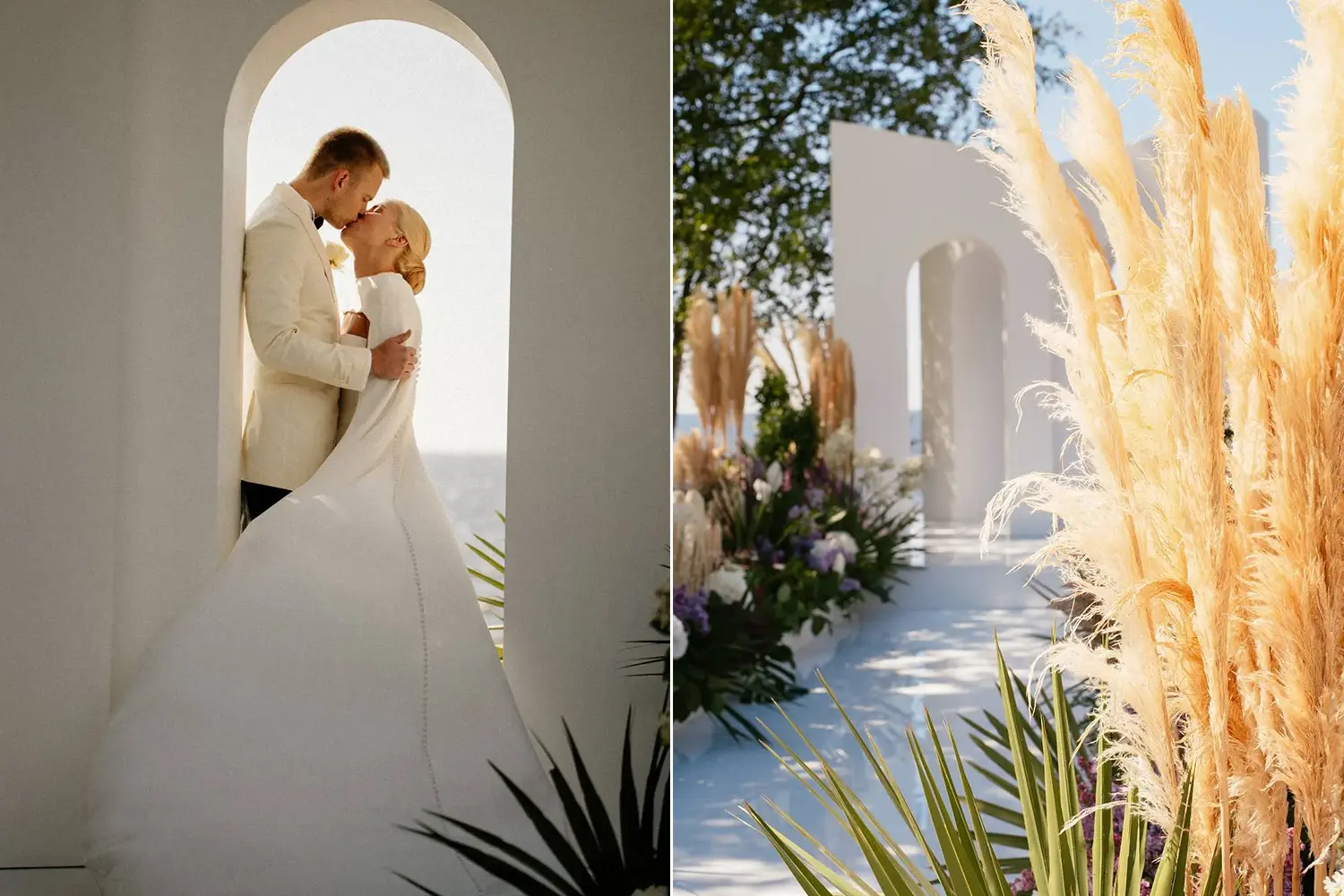 A romantic boho-themed wedding setting featuring a couple embracing under a white arched structure, with pampas grass, tropical greenery, and vibrant floral arrangements surrounding the ceremony area. The bride wears a long-sleeved gown with a train, and the groom dons a cream suit, set against a serene outdoor backdrop.